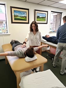 Siena assists patient performing shoulder exercises