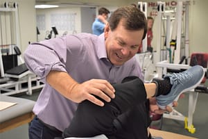 Tom Suspenski works with a patient