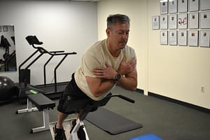 client builds strength using a back extension machine