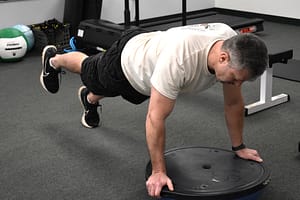 client exercises using a balance trainer ball