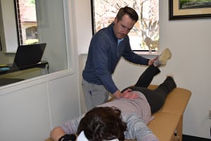 Chris stretches lower back for patient