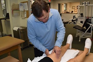 Tom manually massages incision following knee replacement surgery